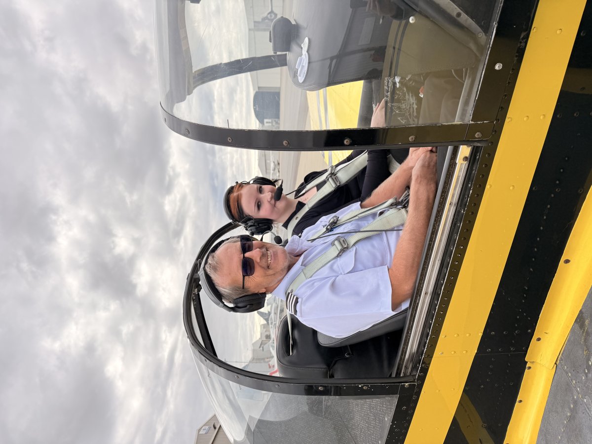 flight instructor teaching student pilot in cockpit training
